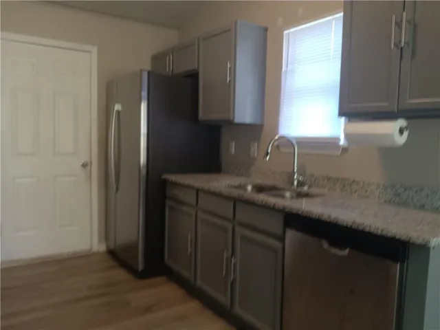 a kitchen with a sink and a refrigerator