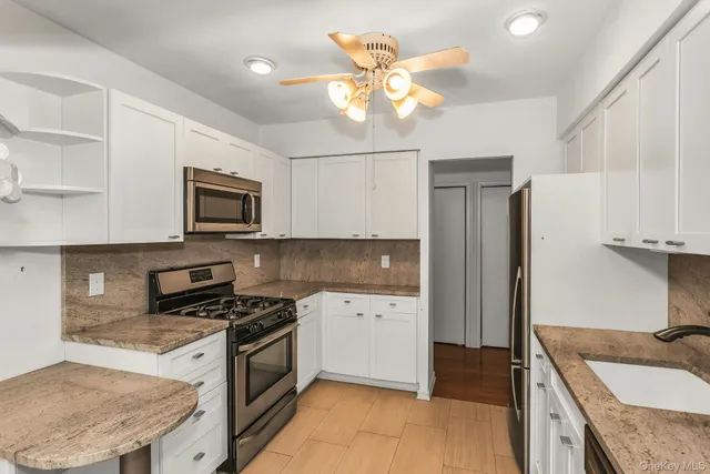 a kitchen with a sink stove and microwave