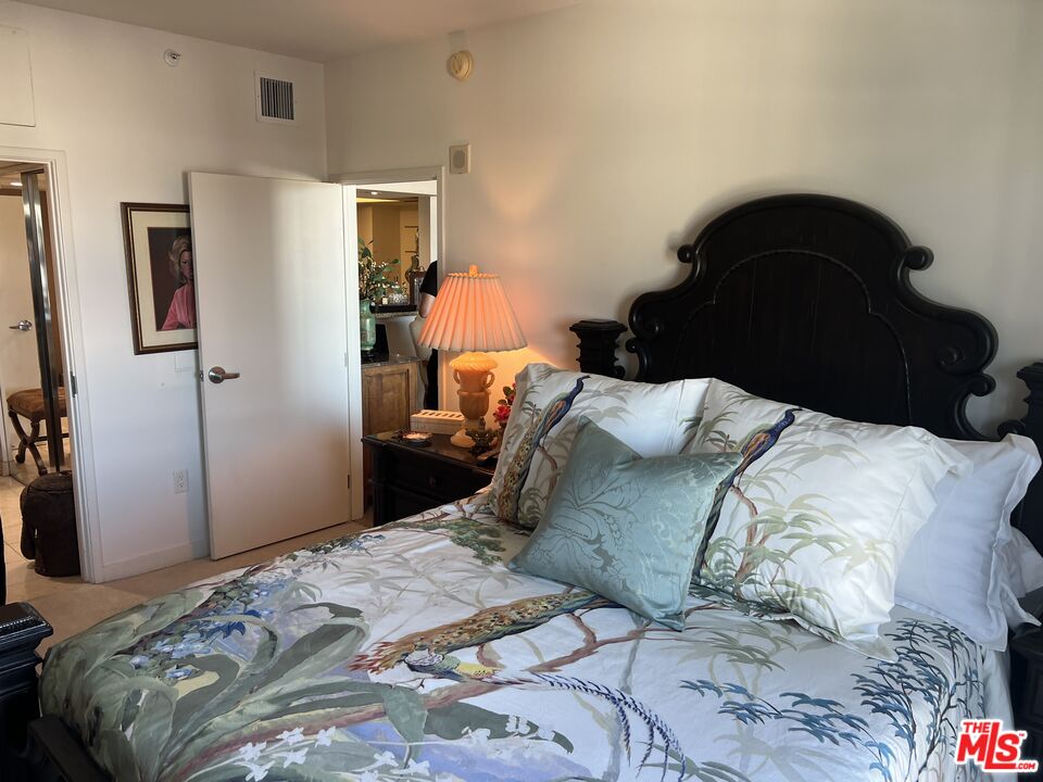 13700 Marina Pointe Drive, Unit 722 Marina del Rey, CA 90292 - Photo 21 of 52 a bedroom with a bed and a closet