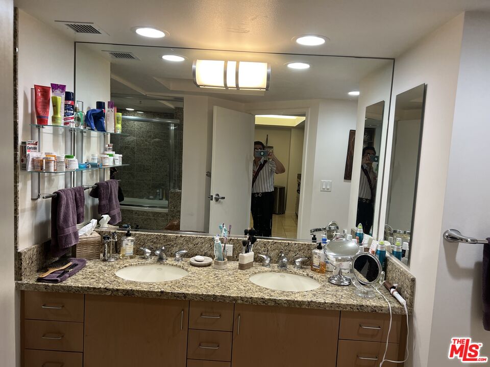 13700 Marina Pointe Drive, Unit 722 Marina del Rey, CA 90292 - Photo 23 of 52 a bathroom with a granite countertop sink double vanity and a mirror