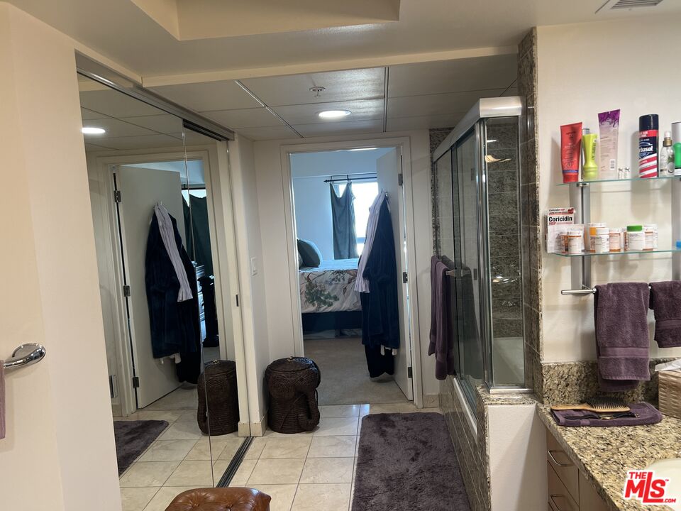 13700 Marina Pointe Drive, Unit 722 Marina del Rey, CA 90292 - Photo 25 of 52 a bathroom with a double vanity sink and shower