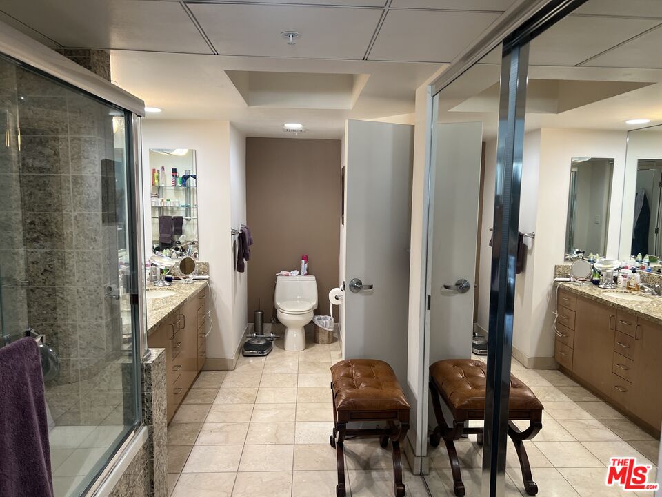 13700 Marina Pointe Drive, Unit 722 Marina del Rey, CA 90292 - Photo 26 of 52 a large bathroom with a glass door shower and sink