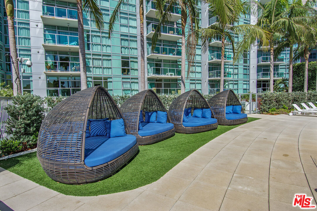 13700 Marina Pointe Drive, Unit 722 Marina del Rey, CA 90292 - Photo 39 of 52 a view of swimming pool with outdoor seating and plants