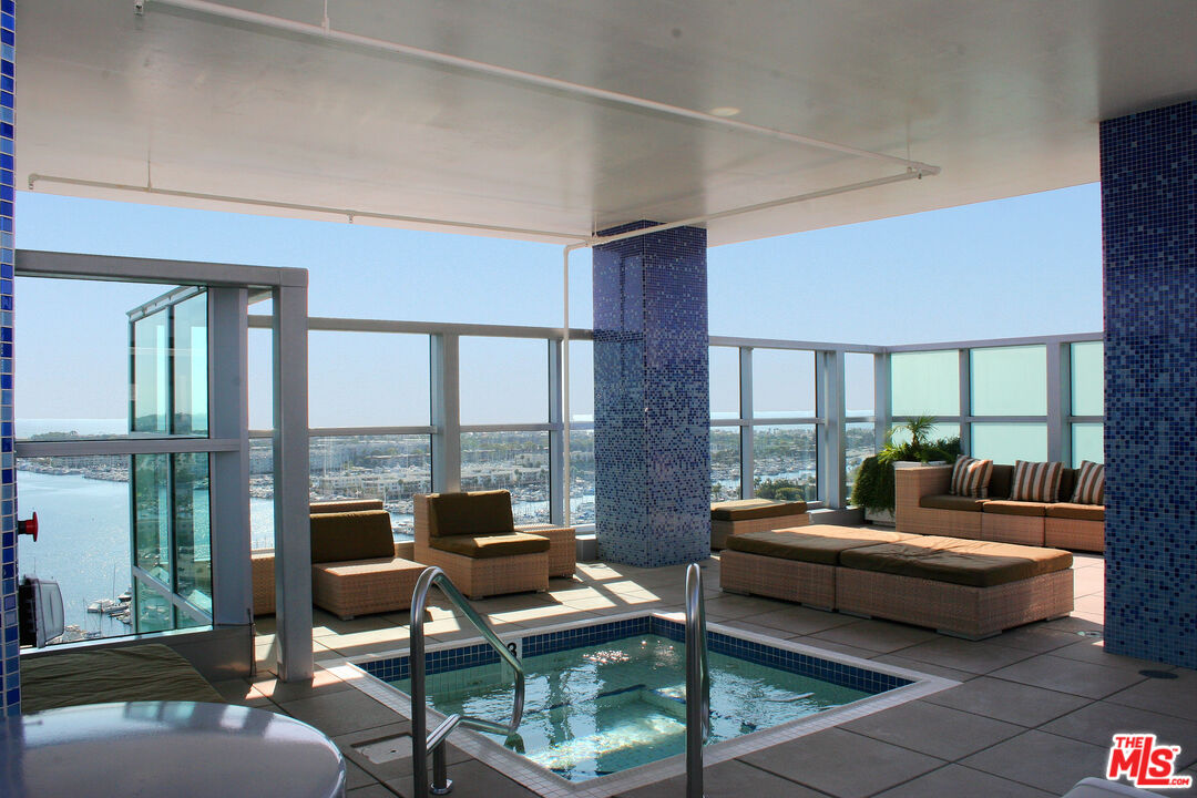 13700 Marina Pointe Drive, Unit 722 Marina del Rey, CA 90292 - Photo 51 of 52 a living room with furniture and a floor to ceiling window
