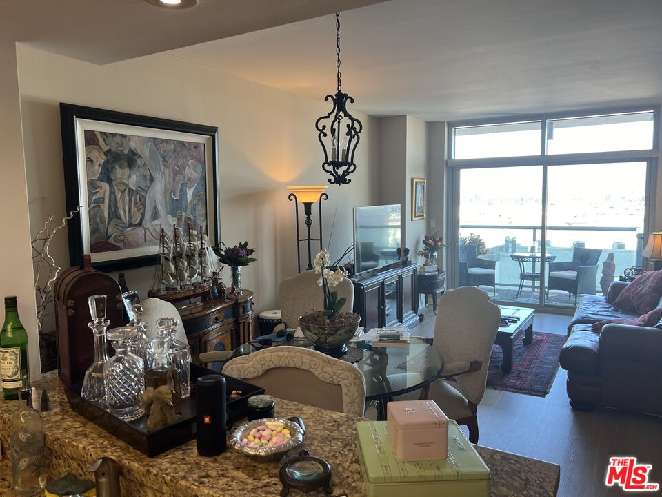 13700 Marina Pointe Drive, Unit 722 Marina del Rey, CA 90292 - Photo 10 of 52 a living room with furniture chandelier and a window