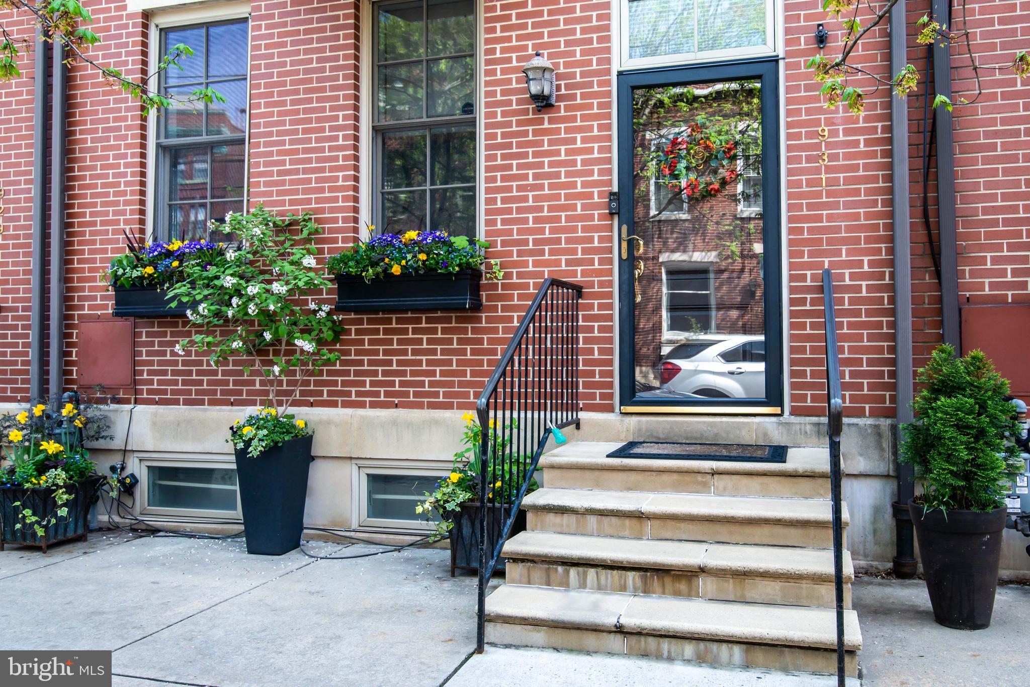 a view of a house with potted plants