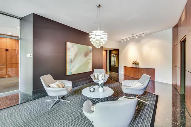 a view of a dining room with furniture wooden floor and chandelier
