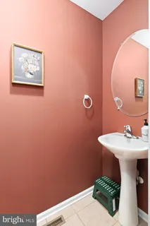 a bathroom with a sink mirror and vanity