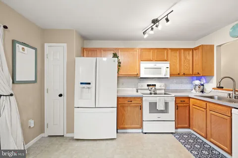 a kitchen with stainless steel appliances granite countertop a refrigerator sink and cabinets