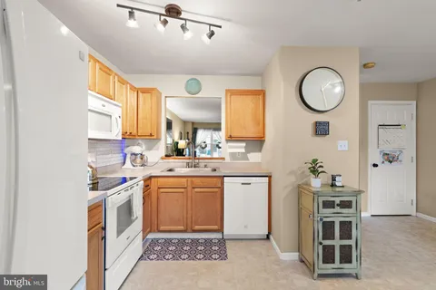 a kitchen with a sink cabinets and window