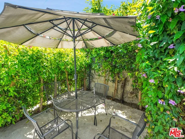 a patio with a yard table and chairs