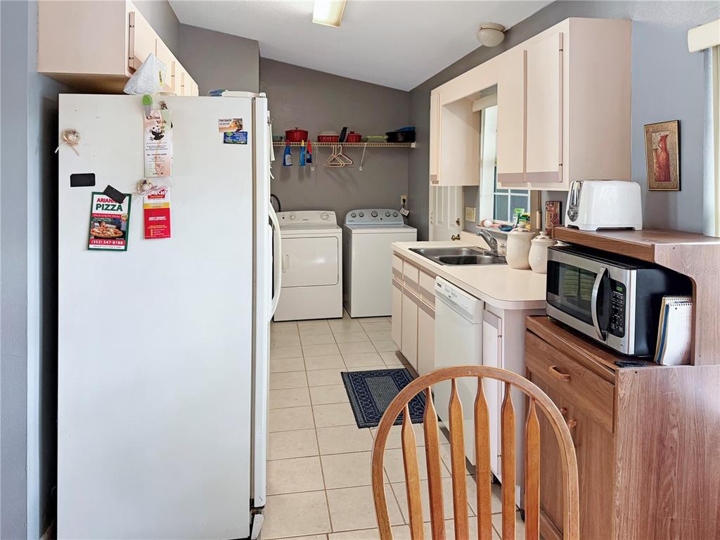5730 Southeast 41st Street Ocala, FL 34480 - Photo 16 of 27 a kitchen with stainless steel appliances granite countertop a stove a refrigerator and a microwave