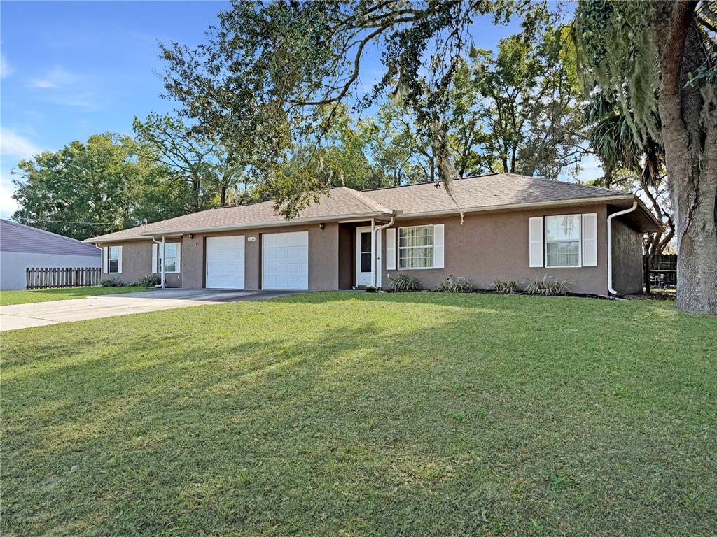 5730 Southeast 41st Street Ocala, FL 34480 - Photo 2 of 27 a front view of house with yard and green space