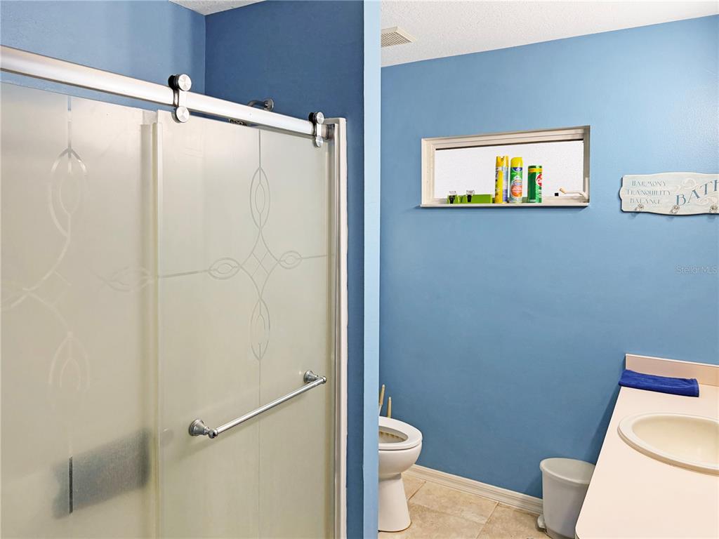 5730 Southeast 41st Street Ocala, FL 34480 - Photo 21 of 27 a bathroom with a toilet and a shower