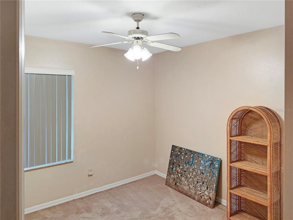 5730 Southeast 41st Street Ocala, FL 34480 - Photo 22 of 27 an empty room with windows and fan