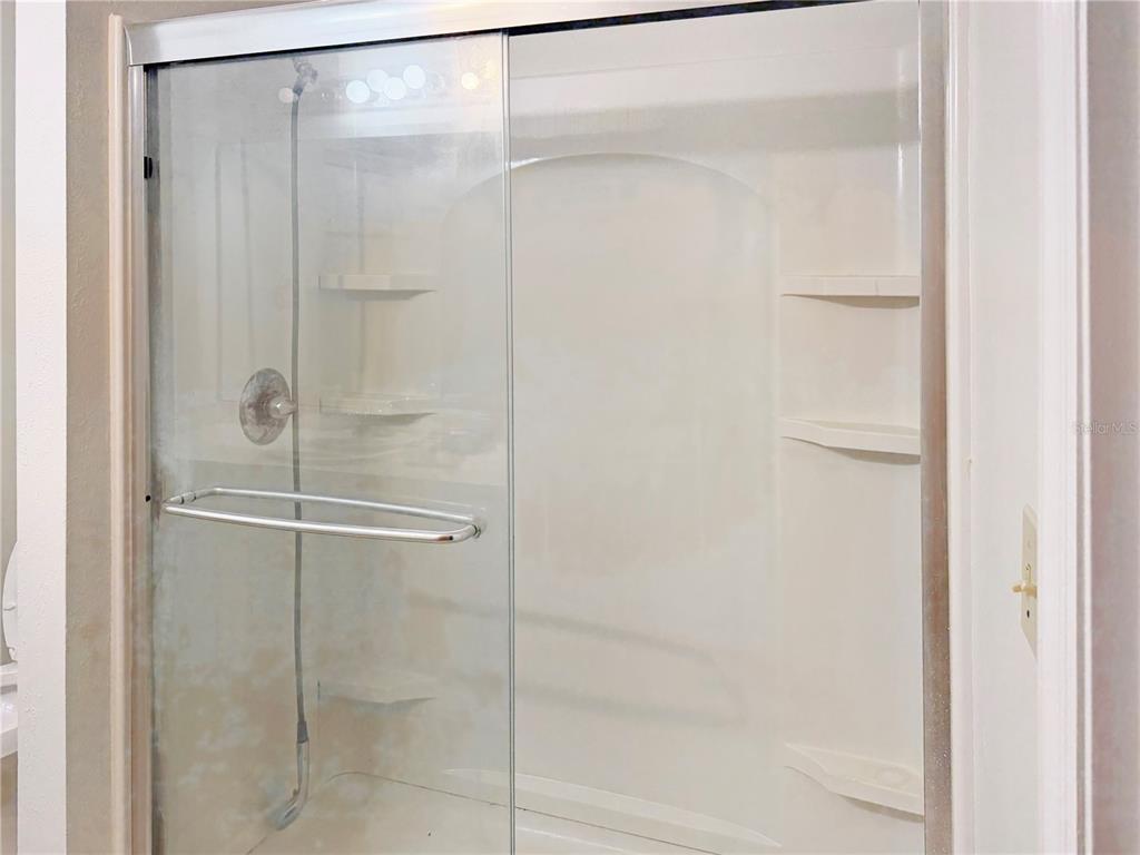 5730 Southeast 41st Street Ocala, FL 34480 - Photo 8 of 27 a bathroom with a glass shower door
