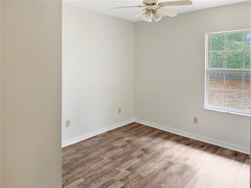 5730 Southeast 41st Street Ocala, FL 34480 - Photo 9 of 27 an empty room with a window and a fan