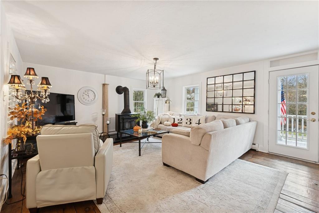 3024 Hyland Road Irwin, PA 15642 - Photo 15 of 45 a living room with furniture a fireplace and a flat screen tv