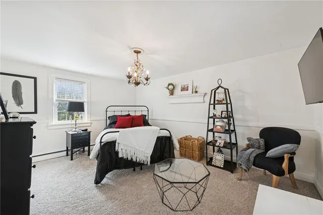 a bedroom with furniture and a window