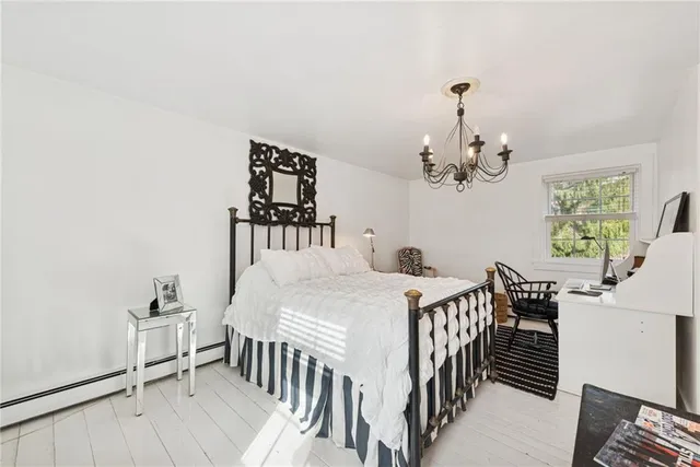 a bedroom with furniture and a chandelier