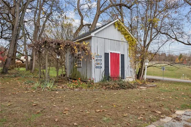a view of a house with large trees