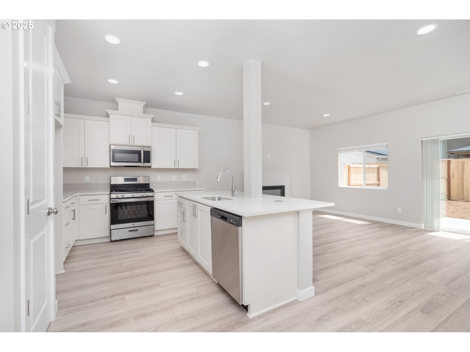 2724 South Ivy Street, Unit 837 Cornelius, OR 97113 - Photo 21 of 24 a kitchen with white cabinets and stainless steel appliances