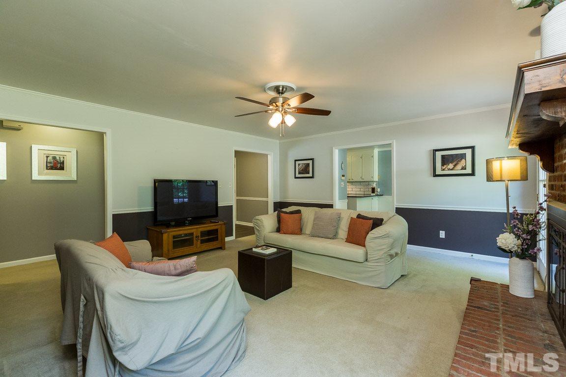 2101 Howson Road Raleigh, NC 27603 - Photo 12 of 25 a living room with furniture a ceiling fan and a rug