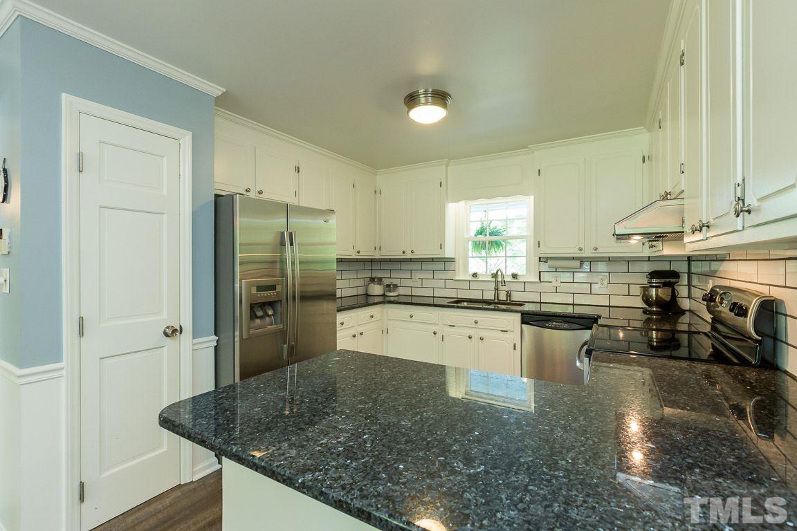 2101 Howson Road Raleigh, NC 27603 - Photo 15 of 25 a kitchen with stainless steel appliances granite countertop a sink refrigerator and cabinets