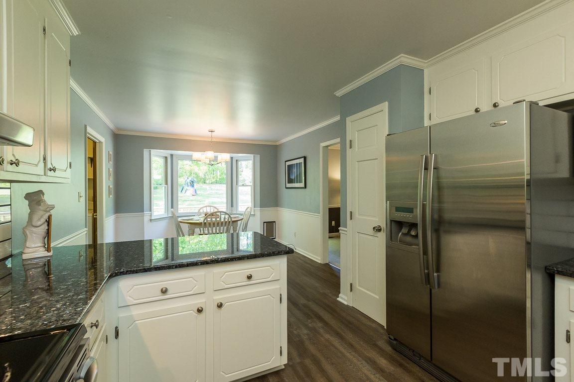 2101 Howson Road Raleigh, NC 27603 - Photo 16 of 25 a kitchen with a refrigerator and countertop sink