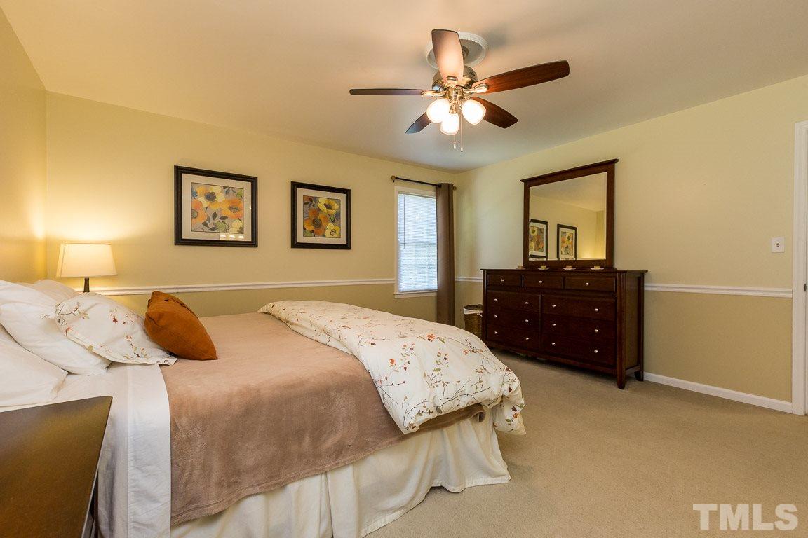2101 Howson Road Raleigh, NC 27603 - Photo 19 of 25 a bedroom with a bed window and dresser