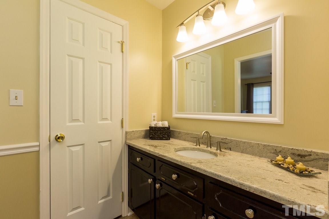 2101 Howson Road Raleigh, NC 27603 - Photo 20 of 25 a bathroom with a granite countertop sink and a mirror