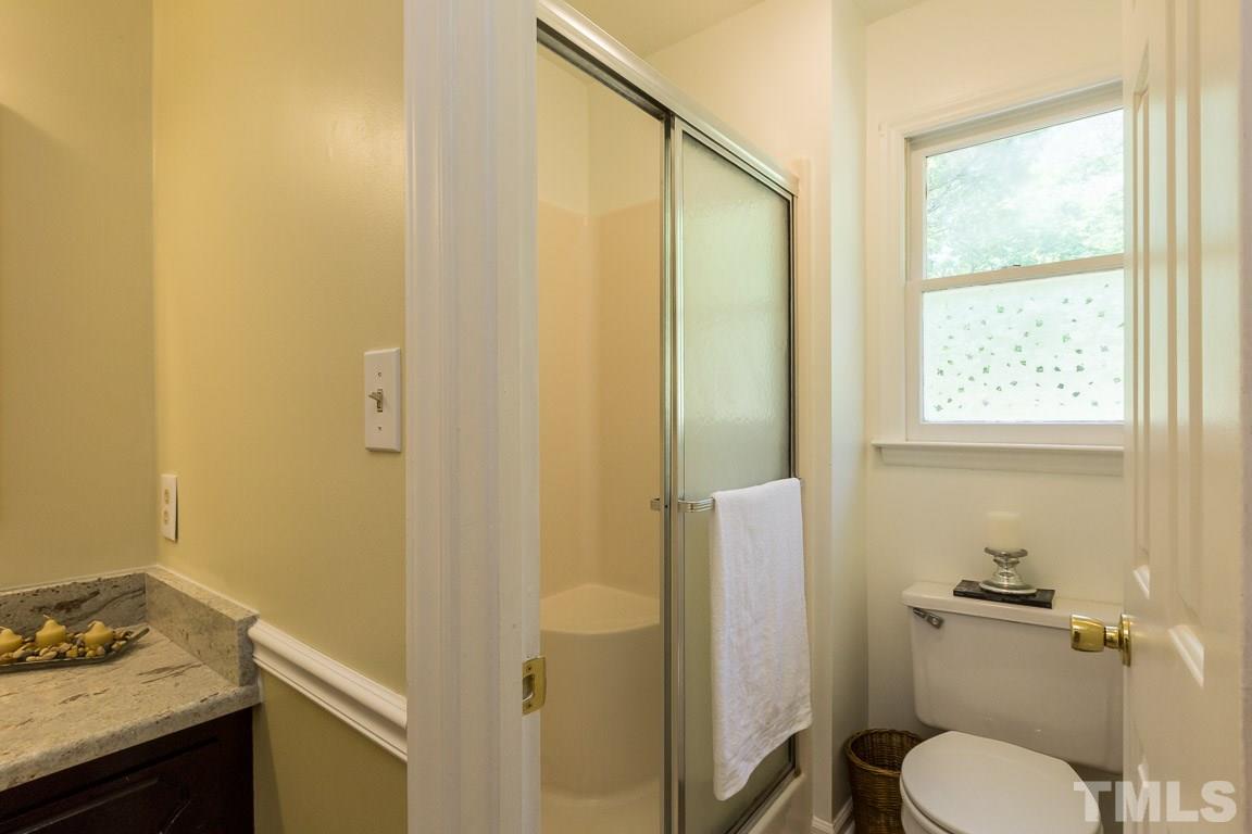 2101 Howson Road Raleigh, NC 27603 - Photo 21 of 25 a bathroom with a granite countertop sink toilet and shower