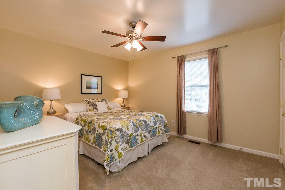 2101 Howson Road Raleigh, NC 27603 - Photo 22 of 25 a bed room with a bed and a chandelier