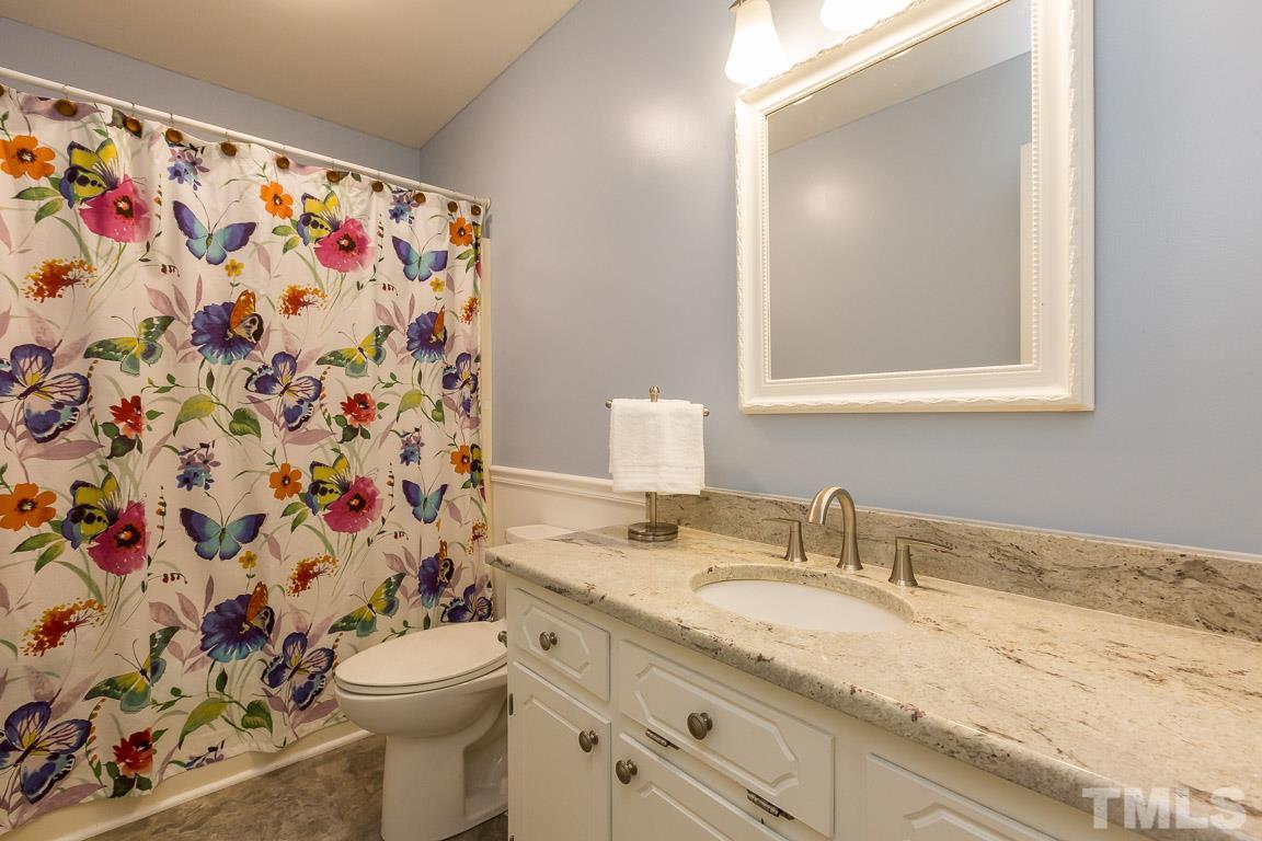 2101 Howson Road Raleigh, NC 27603 - Photo 25 of 25 a bathroom with a granite countertop sink mirror vanity and toilet