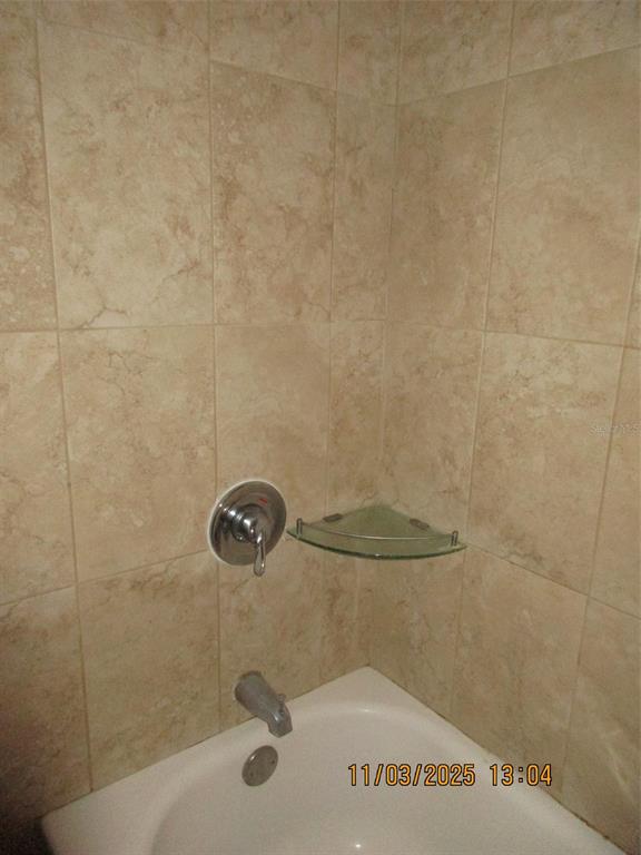 291 Flower Lane, Unit A Kissimmee, FL 34743 - Photo 15 of 40 a bathroom with a shower