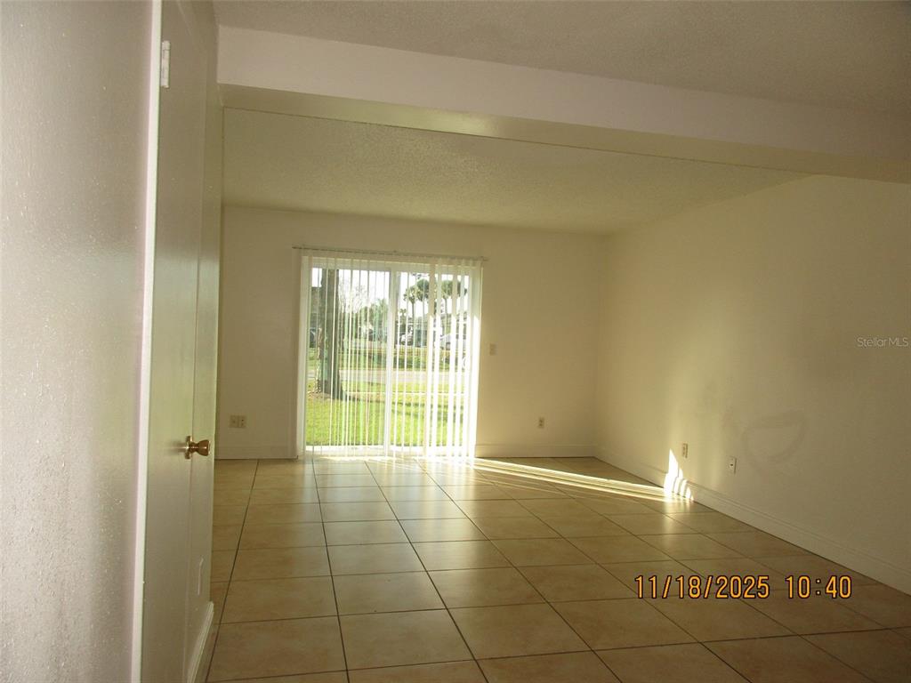291 Flower Lane, Unit A Kissimmee, FL 34743 - Photo 22 of 40 a view of an empty room and window