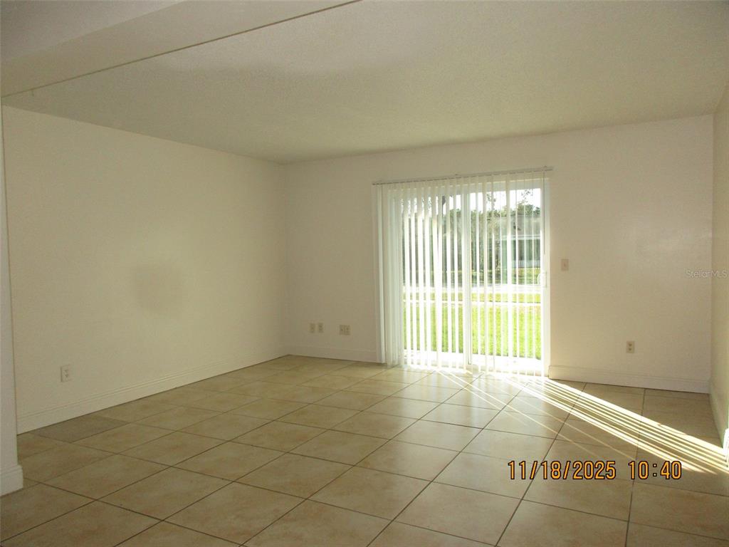 291 Flower Lane, Unit A Kissimmee, FL 34743 - Photo 23 of 40 a view of an empty room with a window