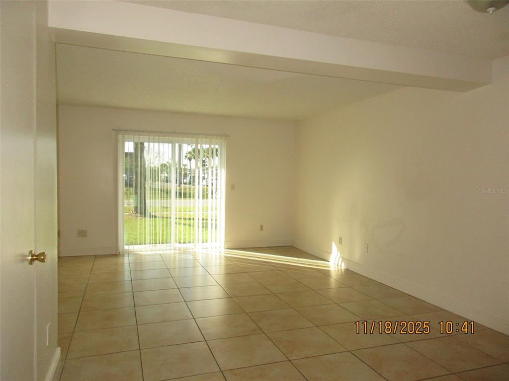 291 Flower Lane, Unit A Kissimmee, FL 34743 - Photo 29 of 40 a view of an empty room with a window