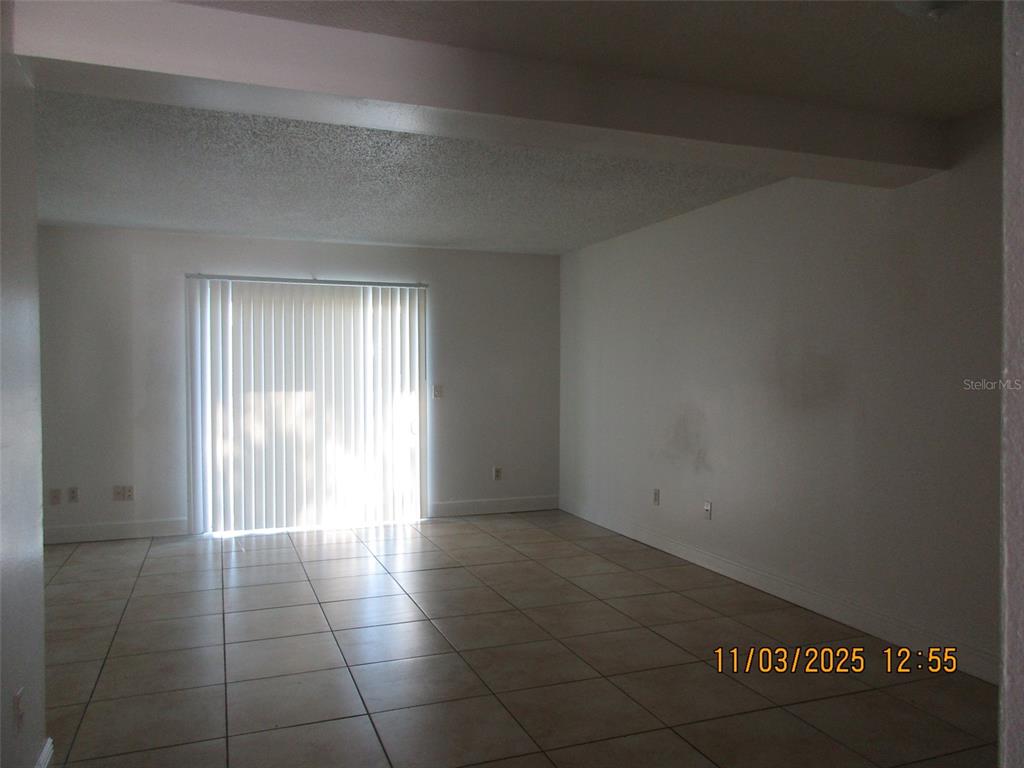 291 Flower Lane, Unit A Kissimmee, FL 34743 - Photo 3 of 40 a view of an empty room and window