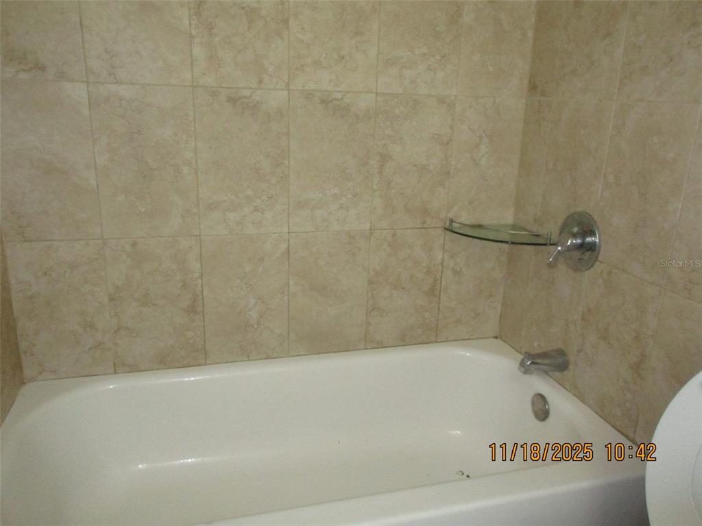 291 Flower Lane, Unit A Kissimmee, FL 34743 - Photo 34 of 40 a bathroom with a bathtub