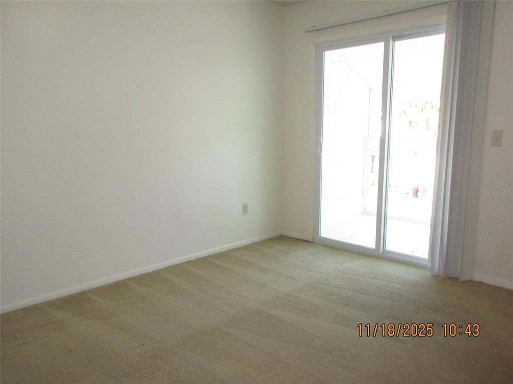 291 Flower Lane, Unit A Kissimmee, FL 34743 - Photo 36 of 40 an empty room with a window