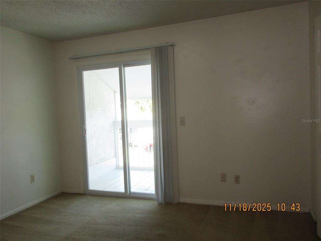 291 Flower Lane, Unit A Kissimmee, FL 34743 - Photo 37 of 40 an empty room with windows