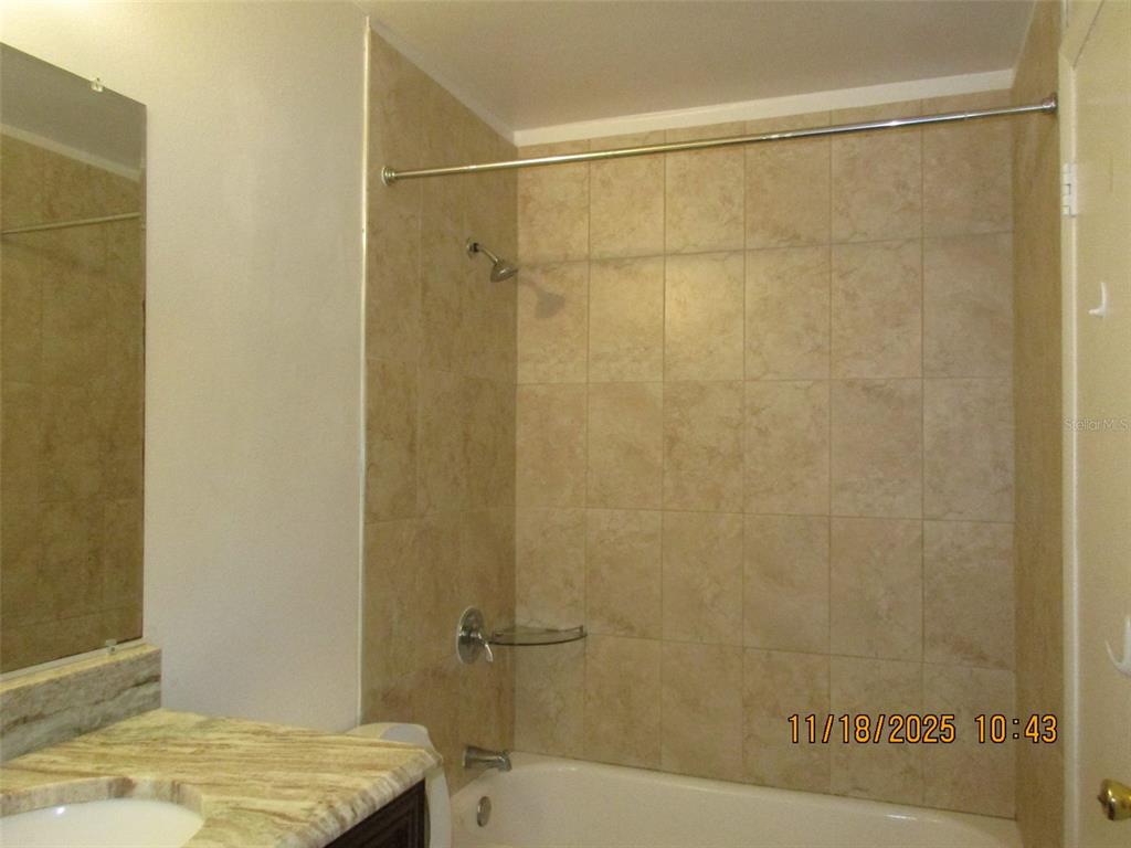 291 Flower Lane, Unit A Kissimmee, FL 34743 - Photo 39 of 40 a bathroom with a shower