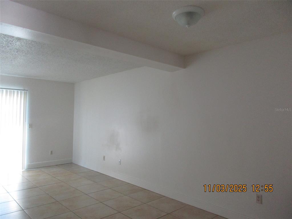 291 Flower Lane, Unit A Kissimmee, FL 34743 - Photo 4 of 40 a view of a room that has a window in it