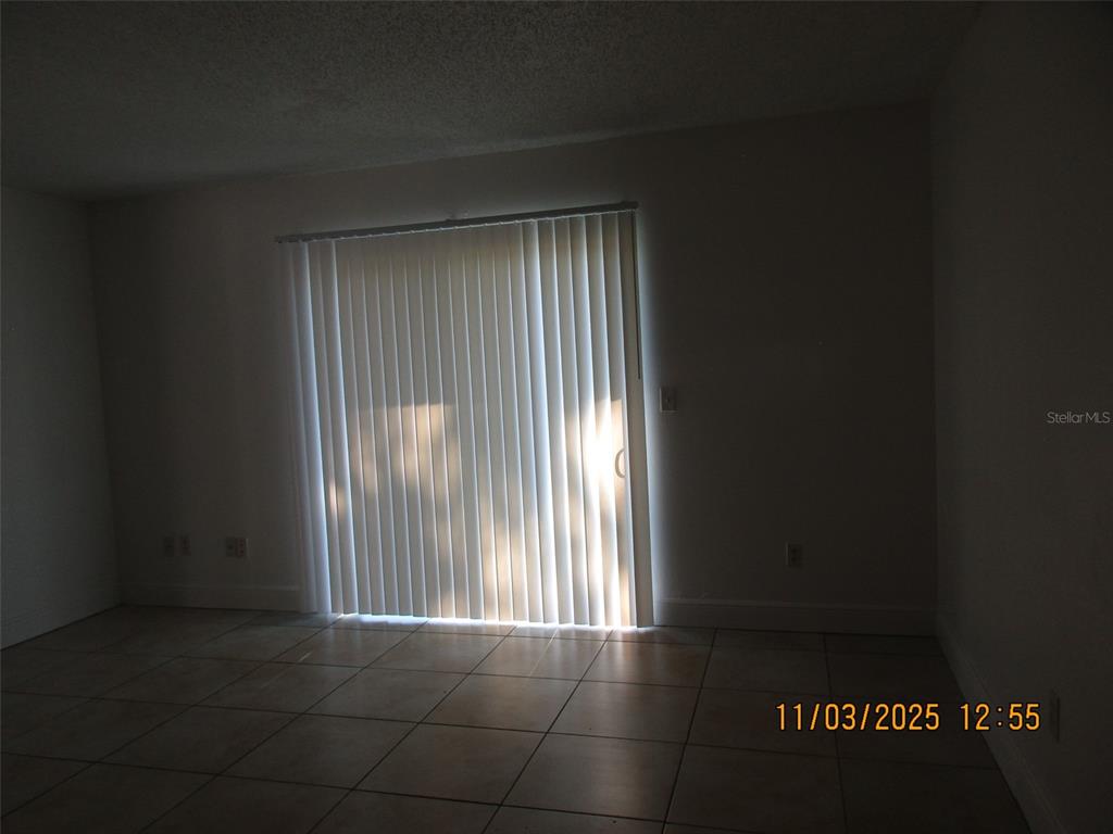 291 Flower Lane, Unit A Kissimmee, FL 34743 - Photo 5 of 40 a view of an empty room with a window