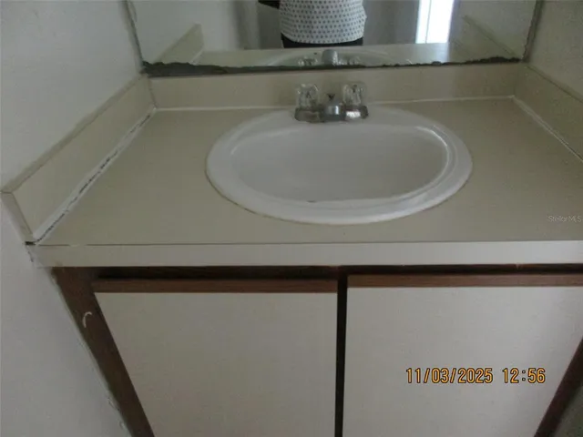 a bathroom with a sink and mirror