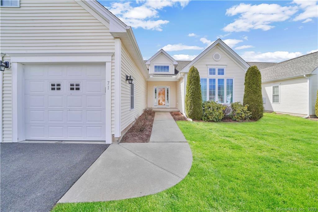 71 Boysenberry Court, Unit 71 Suffield, CT 06078 - Photo 1 of 1 a view of a brick house with a yard and potted plants