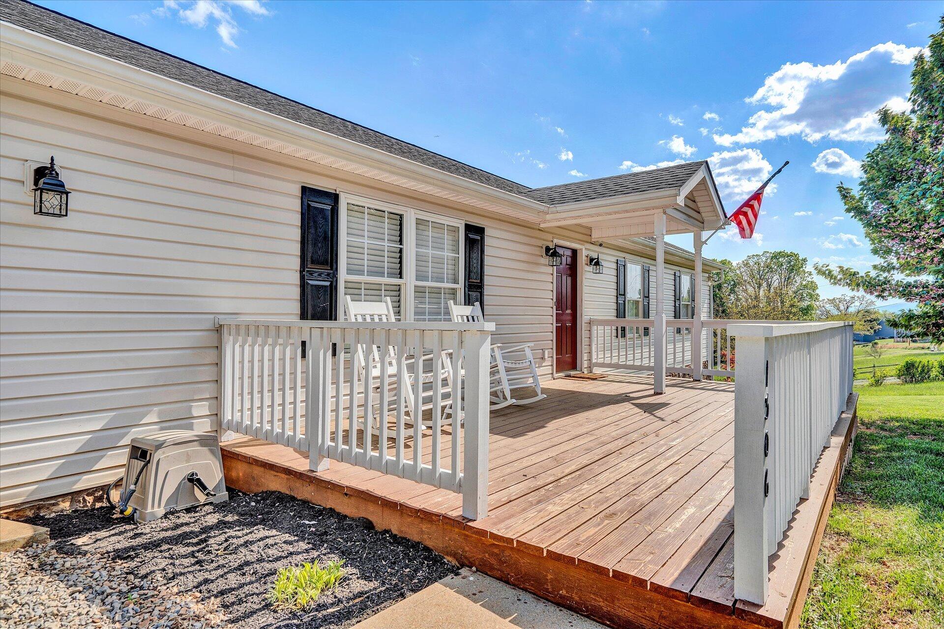 1306 Turner Branch Road Goodview, VA 24095 - Photo 16 of 21 a porch with a bench next to a yard