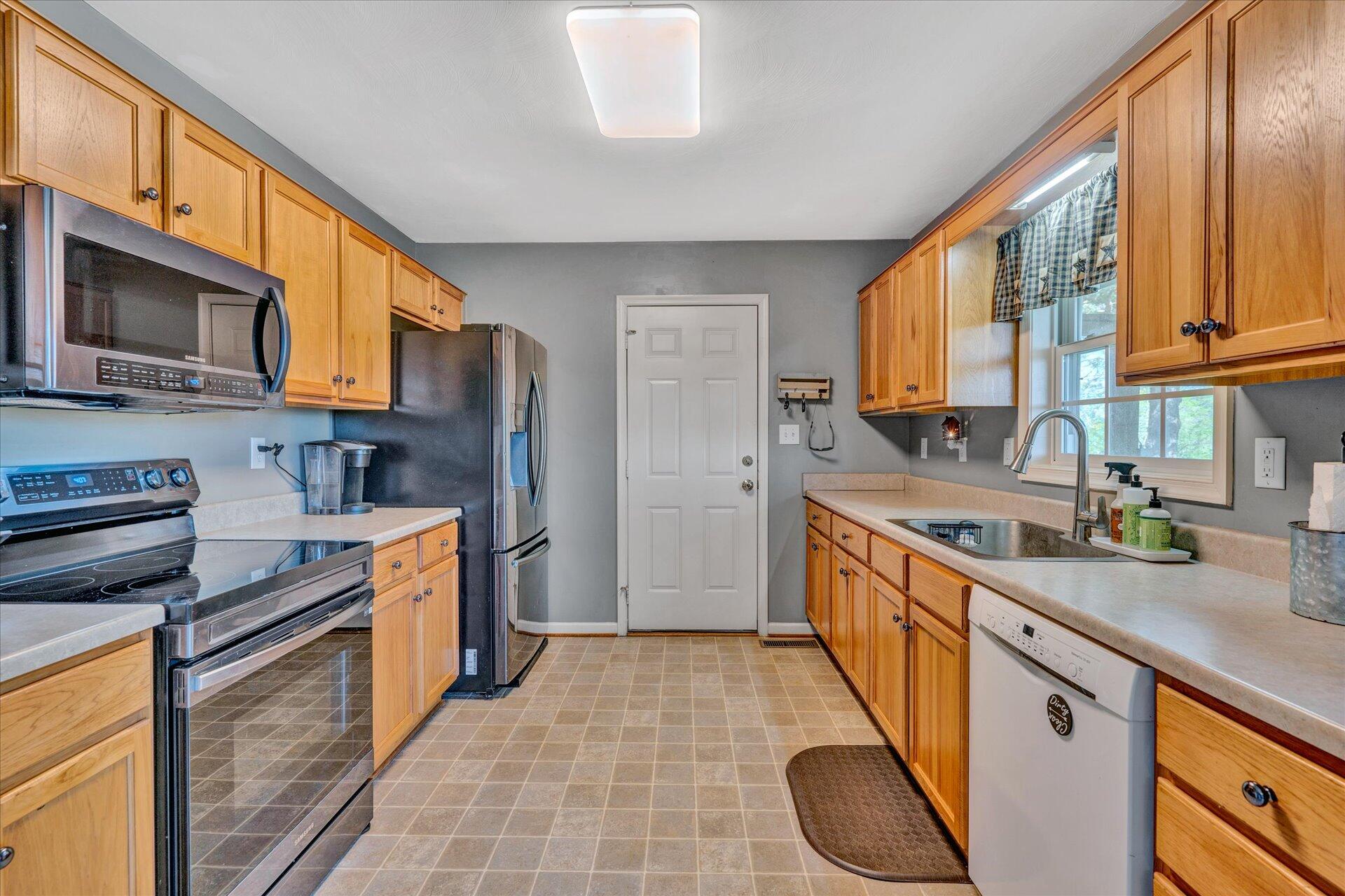 1306 Turner Branch Road Goodview, VA 24095 - Photo 7 of 21 a kitchen with stainless steel appliances granite countertop a stove sink and cabinets