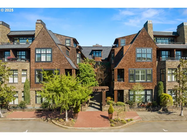 a front view of a residential apartment building with a yard